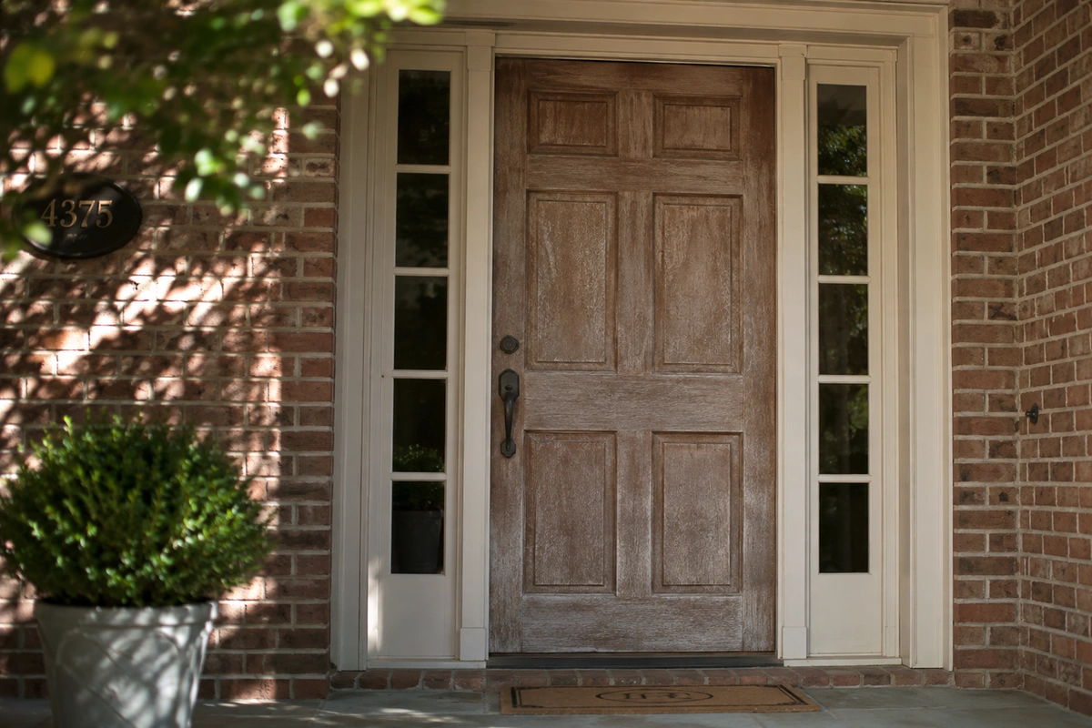 Sun-faded and cracked wood front door before refinishing in Dunwoody, GA